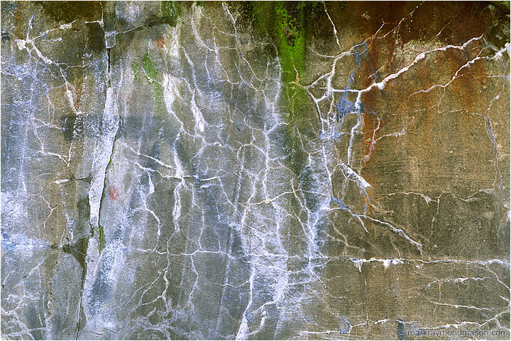 Cracked Concrete: Vancouver, BC, Canada (2005-00-00) - Abstract photograph showing graffiti and patterned cracks in concrete wall