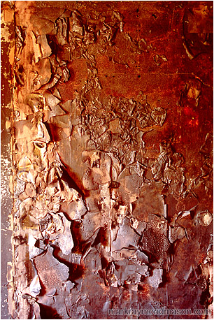 Abstract fine art photograph of a burnt, blistered wall inside a fire-damaged house