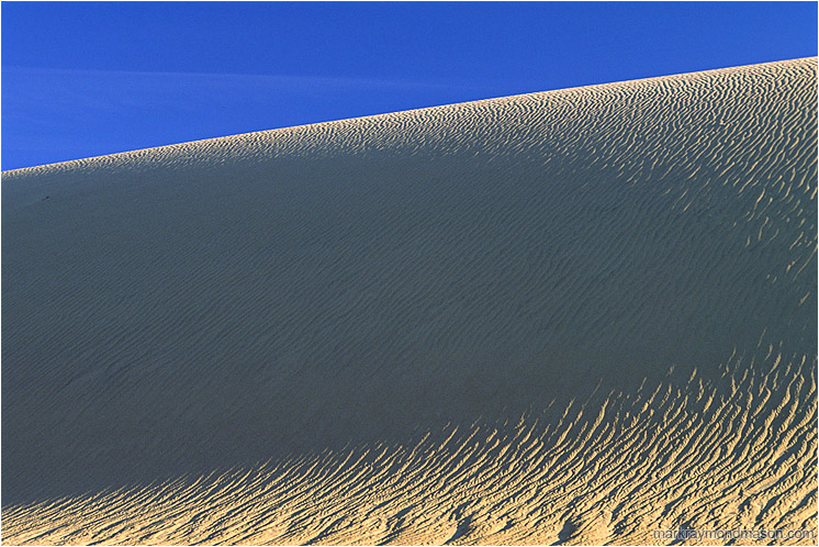 Dune, Shadows: Death Valley, CA, USA (2003-00-00) - Abstract nature photograph of shadows in a sand dune and pale blue sky