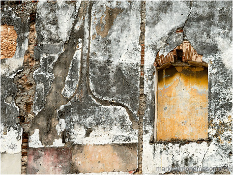 Fine art photo showing a wall next to a demolished structure, the missing adjoining walls clearly visible