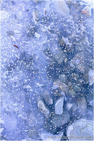 Abstract photo showing rocks and ice, dusted with snow crystals