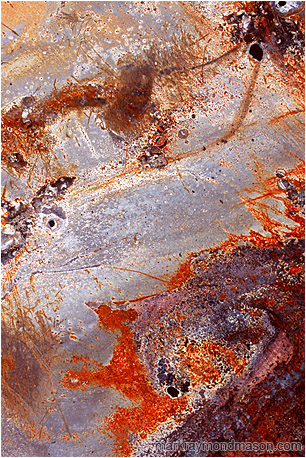 Fine art photograph of brushings, chipping paint, and swirling scratches on the surface of a piece of twisted sheet metal