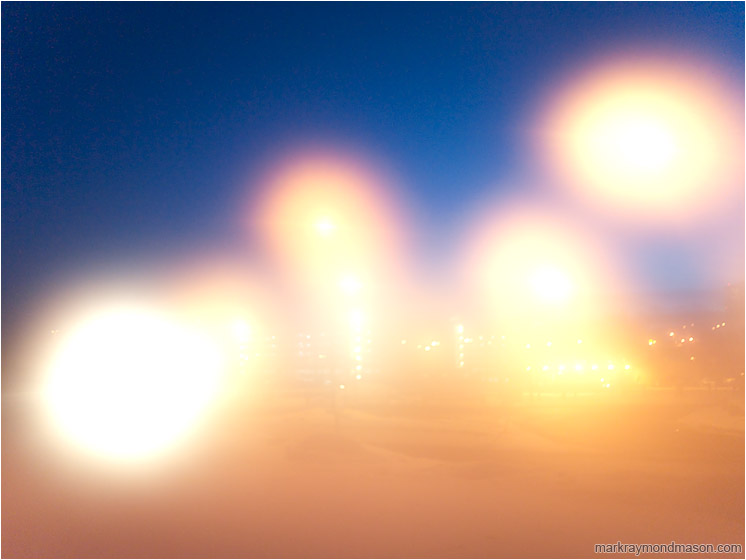 Light Circles, Night Sky: Calgary, AB, Canada (2010-02-01) - Abstract photograph of street lamps and lens flare against a dark night sky