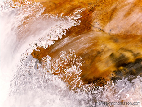 Fine art photo showing cascading water frozen into a sharp peaked wave in an alpine creek