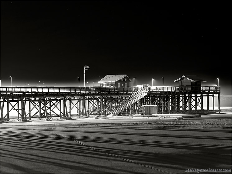 Wharf, Lamplight, Winter Fog: Salmon Arm, BC, Canada (2016-12-30) - Fine art black and white photograph showing a thin shroud of fog around a lone snow-lined wharf on a black winter night