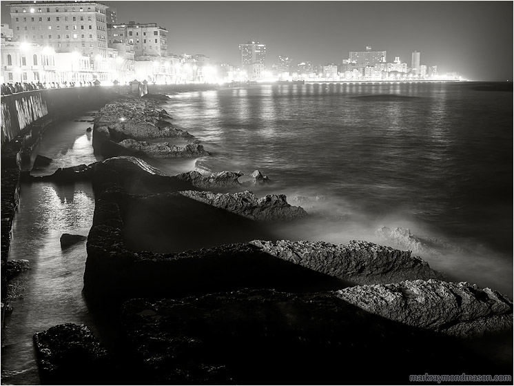 Worn Seawall, Night Skyline: Havana, Cuba (2017-02-17) - Fine art black and white night photograph of waves crashing against worn concrete water barriers