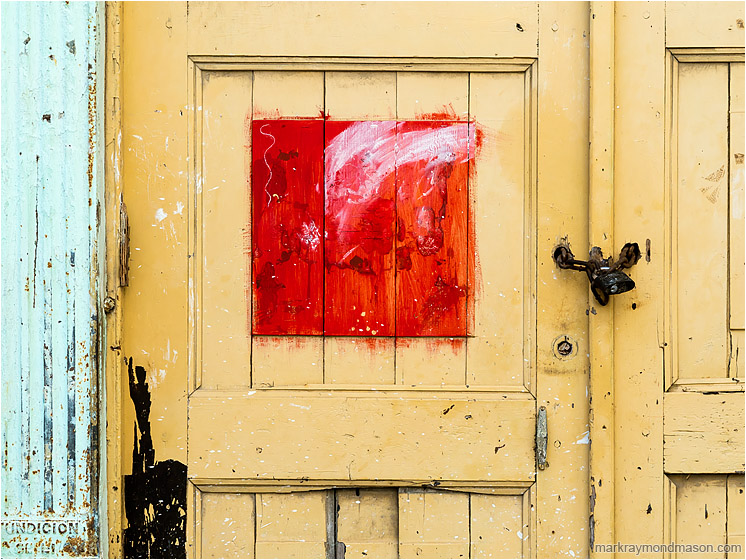 Yellow Door, Red Panel, Lock: Havana, Cuba (2017-02-19) - Fine art abstract photograph showing a red painted square, like a framed picture, in the middle of an ageing wooden door
